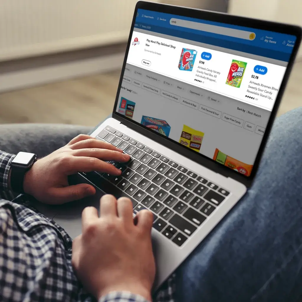 Picture of a marketer on his laptop on the walmart marketplace website